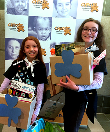Clara and Fiona from the 1st Wakefield Guides with donations for CHEO