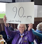 Trefoil Guild member celebrates 90th birthday with a sign
