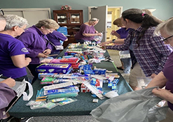The Sisterhood of the Travelling Trefoil Guild packaging personal items for Purses for Margaret